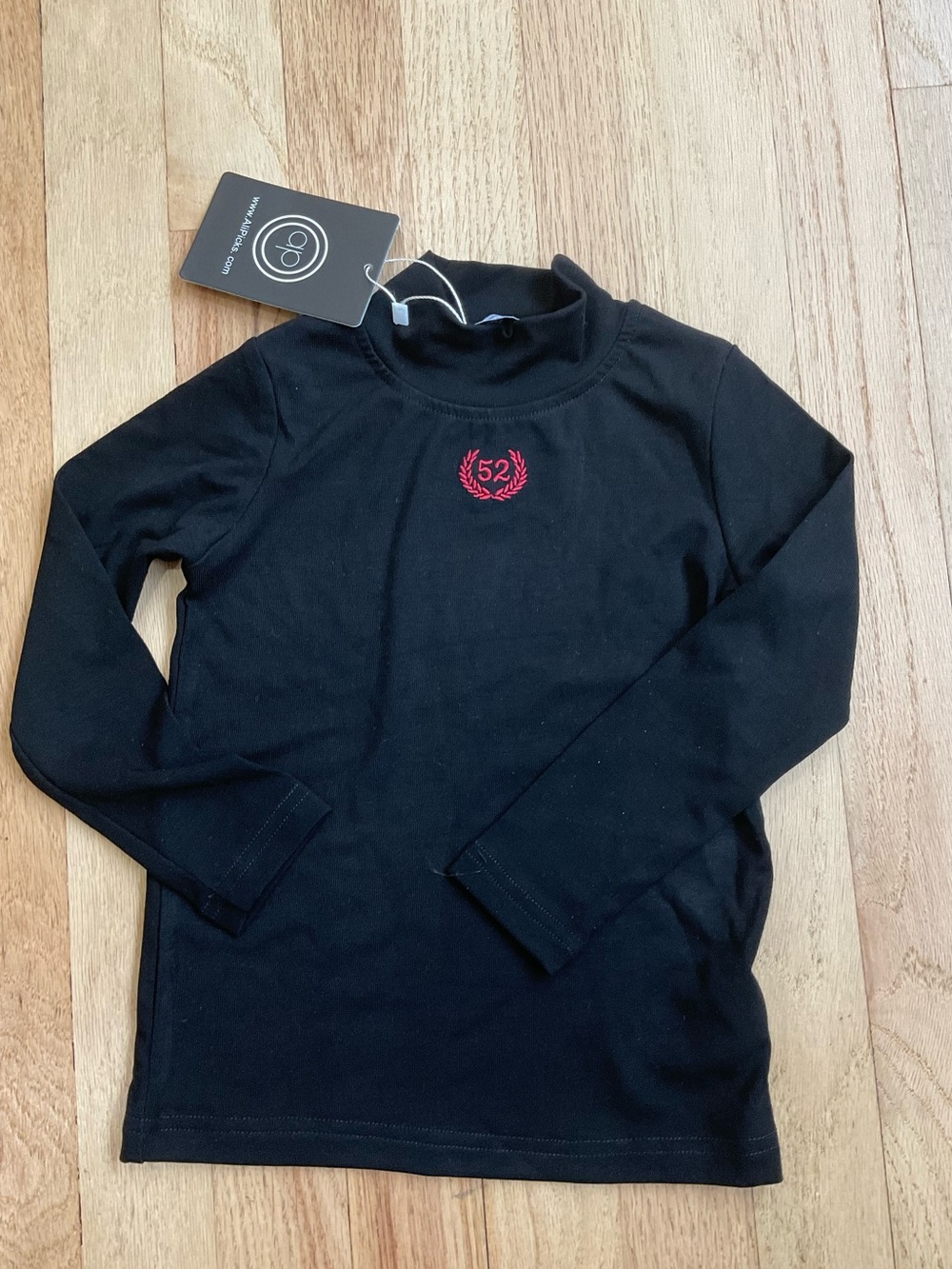 Black Long-Sleeve Kids Top with Red Embroidered Crest